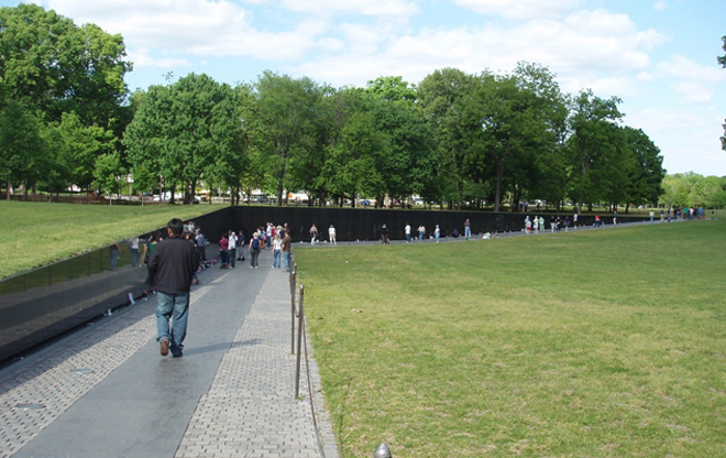 A visit to the wall can be solemn; people can be seeking the name of a loved one or recognizing immense sacrifice. Photo Credit: National Park Service/American Society of Landscape Architects