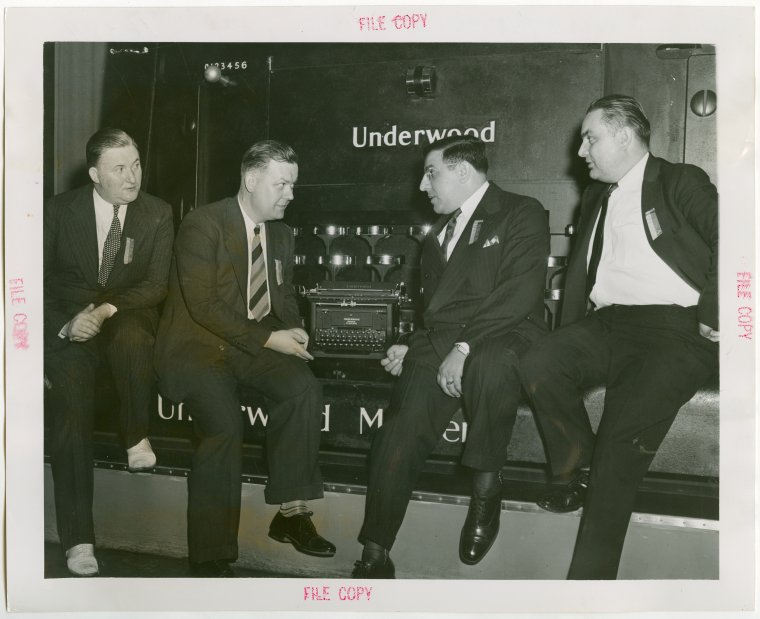 Employees of twenty years who brought the 5 millionth typewriter to the fair exhibit sitting on the typewriter. Photo Credit: New York Public Library