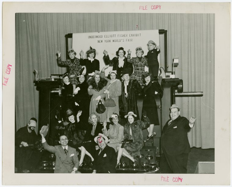 A happy group poise with the giant typewriter. Photo Credit: New York Public Library