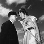 "Umpire-Player Argument: For all the head-to-head 'ferocity' player Marie Wegman, 22, Cincinnati, Ohio, meekly asks umpire Norris Ward, 'sure you're right about that play?' Wegman is 6'2". She plays infield and 2nd base for Ft. Wayne, last year played for Rockford club." (Florida Memory)