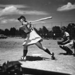 "Hit: Its a hit and batter Dottie Schroeder, blonde pigtails and all, start[s] running for first. Catcher Mary Rountree and Umpire Norris Ward. These girls really hit...and are lightning when running." (Florida Memory)